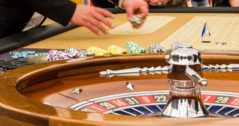 Roulette table and wheel with bettors