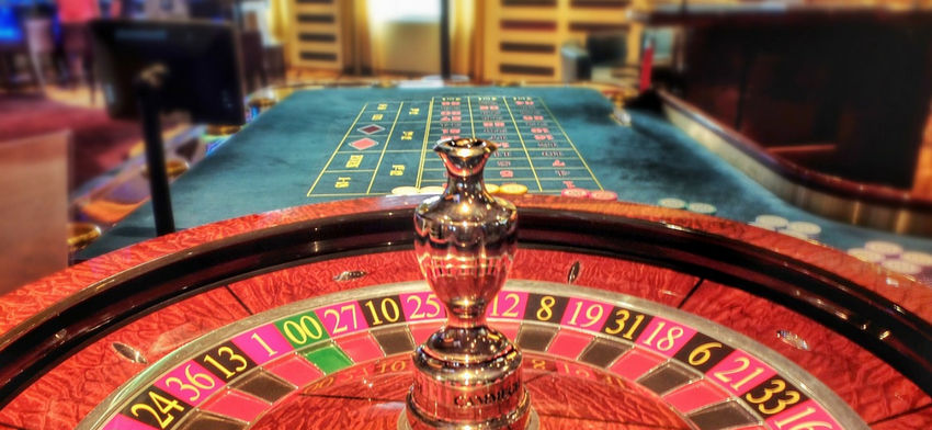 Real roulette wheel in casino with table